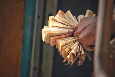 Closeup of Man holding bunch of currency notes in his handの写真素材