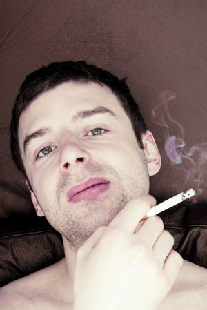 Male with cigarette in hands. 
