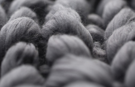 Close-up of knitted grey blanket, merino wool backgroundの写真素材
