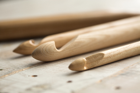 wooden knitting needles on wooden backgroundの写真素材