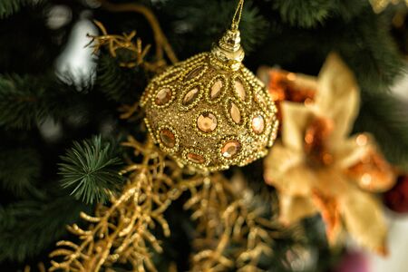Decorations and gold ball on Christmas treeの写真素材
