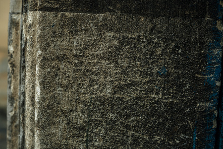 Cracked old stone wall background, dark grunge texture close up.の写真素材