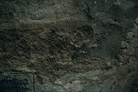 Cracked old stone wall background, dark grunge texture close up.の写真素材