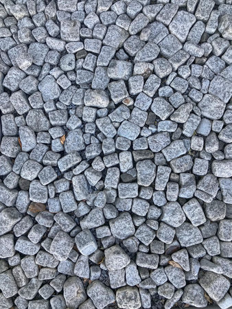 Stones gray paving stones randomly scattered background.の写真素材