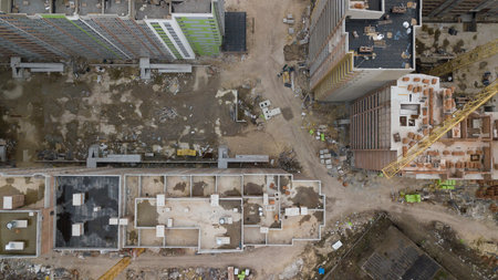 Aerial view on a construction site in progress. Industrial zone. Dirty street and construction...