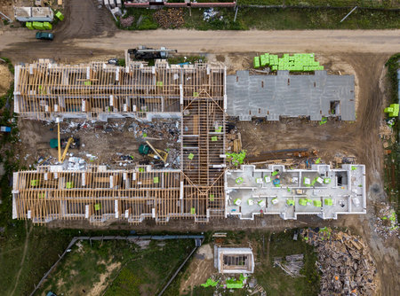 Aerial view on a construction site in progress. Industrial zone. Dirty street and construction...