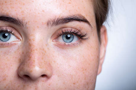 A close up of a person with blue eyes looking at the cameraの写真素材