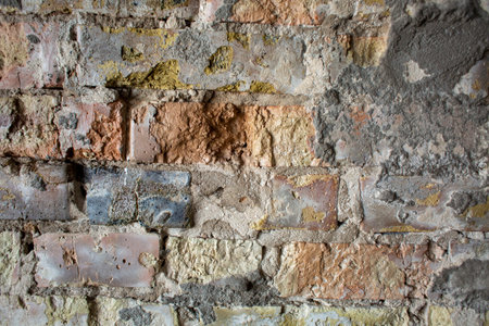 Old yellow damaged brick wall beautiful background
