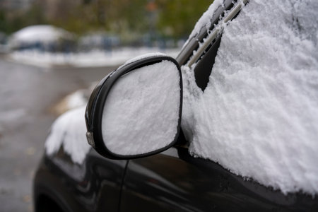 After the snowfall, glass and car mirror in the snowの写真素材