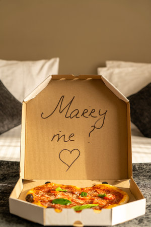 A romantic proposal of love with delicious pizza and the inscription on the box of Merry Meの写真素材