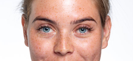 A close up of a person with blue eyes looking at the cameraの写真素材