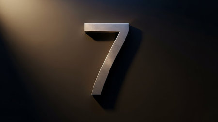 Isolated silver number 7 on a dark surface with spotlightの素材