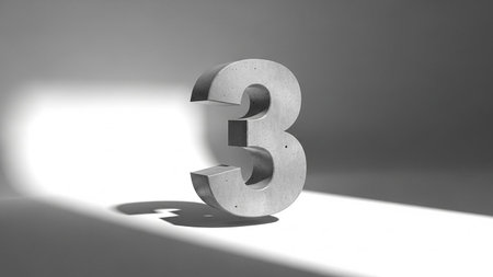 Shiny metal number three illuminated by a spotlight on a dark backgroundの素材