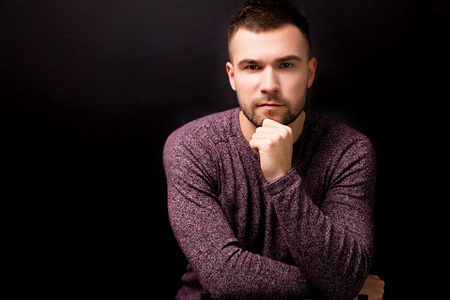 Handsome serious man  isolated on a black backgroundの写真素材