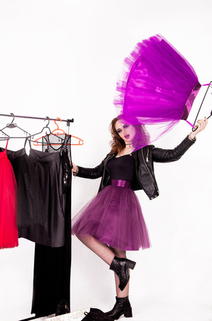 A happy girl in the style of rock chooses clothes among the tulle skirtsの写真素材