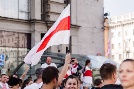 Minsk Belarus - August, 2020:Peaceful protest in Minsk. In the hands of protesters, people carry a white-red-white flag with the chase emblem. Horizontal photoのeditorial素材