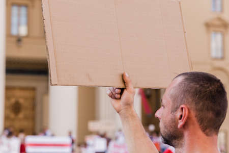Minsk Belarus - August, 2020:Peaceful protest in Minsk. A man stands with his back to the camera with a poster in his hands. Horizontal photoのeditorial素材