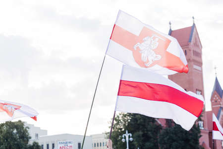 Minsk Belarus - August, 2020:Peaceful protest in Minsk. In the hands of protesters, people carry a white-red-white flag with the chase emblem. Horizontal photoのeditorial素材