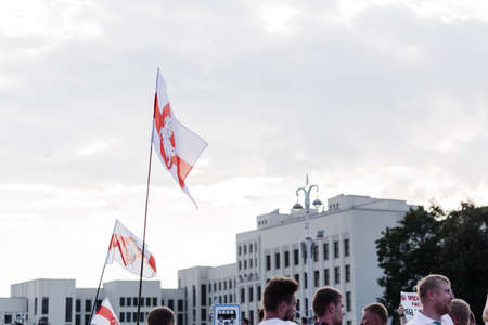 Minsk Belarus - August, 2020: Peaceful protest in Minsk. In the hands of protesters, people carry a white-red-white flag with the chase emblem. Horizontal photoのeditorial素材