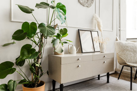 Part of the living room interior. Armchair, chest of drawers, plant and accessories. Horizontal...