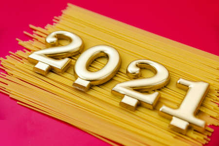 Happy New Year 2021. Symbol from number 2021 and macaroni on red background. Horizontal photoの写真素材