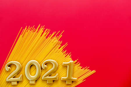 Happy New Year 2021. Symbol from number 2021 and macaroni on red background. Horizontal photoの写真素材