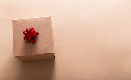 Gift in craft packaging on craft paper background