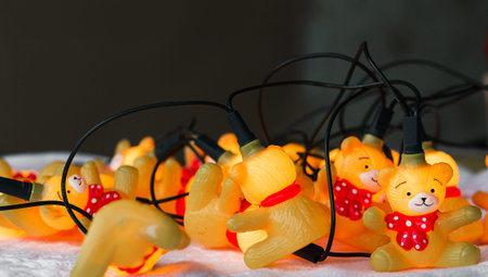 Christmas garland in the form of bears in red sweaters on a white knitted background. Horizontal photoの写真素材