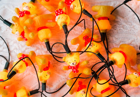 Christmas garland in the form of bears in red sweaters on a white knitted background. Horizontal photoの写真素材
