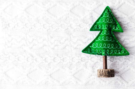 new year christmas textile tree on on a white knitted background. Horizontal photoの写真素材