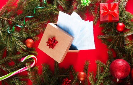 Set of medical protective masks in a gift box on the background of christmas decor. Horizontal photo