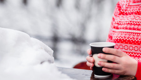 Girl in jeans, pink hoodie and black jacket posing on a city street. Photoの写真素材