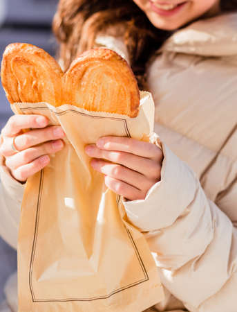 Girl in jeans, pink hoodie and black jacket posing on a city street. Photoの写真素材