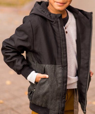 little african american boy pose on a city street in autumn clothes. Photo