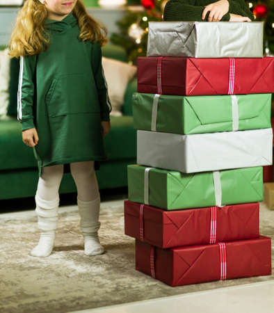 A boy and a girl built a mountain or pyramid from New Year gifts. Photoの写真素材