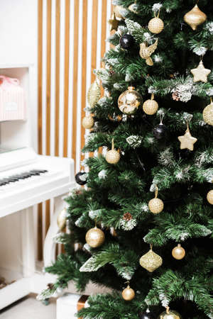 New Year decoration. Christmas tree near white piano in the classic interior. Photoの写真素材