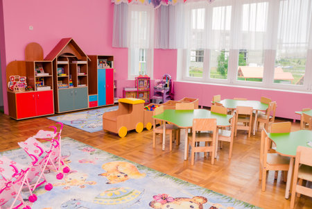 The interior of a group in a kindergarten with a lot of toys, educational games and bright furniture. Horizontal photo. Minsk, Belarus- April 10, 2022のeditorial素材