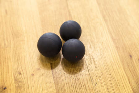 Black squash balls in squash court. Horizontal photoの写真素材