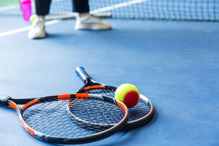 Children's Tennis ball and Tennis Rackets on tennis court. Horizontal photoの写真素材