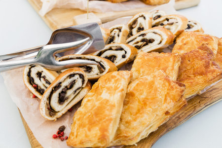 Strudel with mushrooms and puff with chicken and vegetables on a banquet table. There are metal...