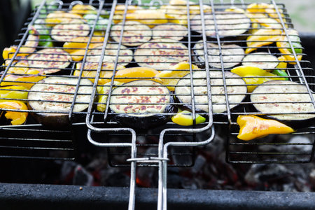 Vegetables on barbecue grill, close-up. Peppers and eggplants on an iron grate. Horizontal photoの写真素材