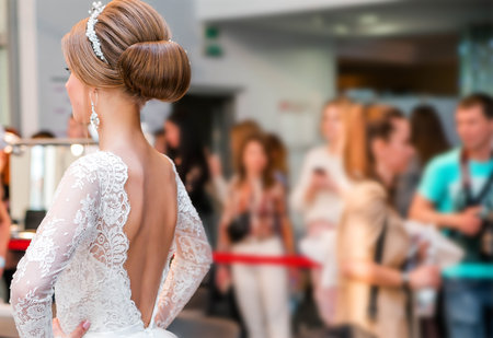 Competition among wedding stylists. A model in a wedding dress, with hair and make-up shows the result of the stylist's work. Horizontal photoの写真素材