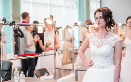 Competition among wedding stylists. Models in wedding dresses, with hair and make-up show the...