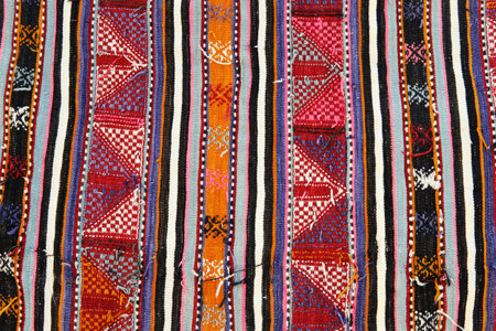 Detailed close-up of a Turkish kilim displaying traditional weaving patterns and vibrant colors.