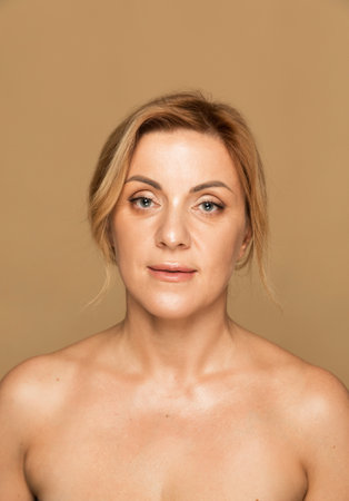 Portrait of a mature woman with a calm and confident expression, highlighting her well-maintained skin and natural beautyの写真素材