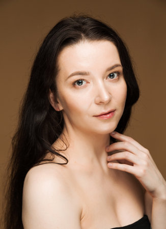 Portrait of a young brunette woman with flawless skin.の写真素材