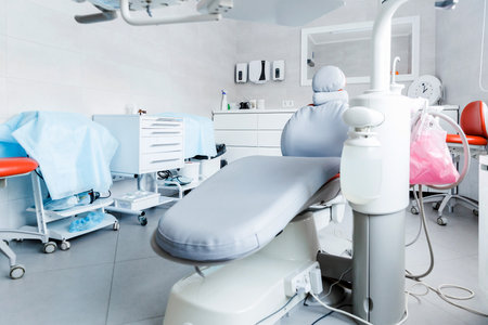 Contemporary dentist office showcasing a dental chair, tools, and organized workspace.の写真素材