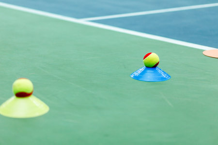 Tennis training setup with cones and balls on a tennis court. Horizontal photo.の写真素材