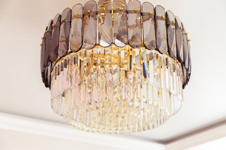 A close-up of an elegant crystal chandelier showing its intricate design and luxurious details, adding a touch of sophistication.の写真素材