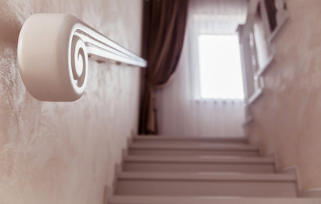 Close-up view of a stylish white handrail on a staircase, highlighting its elegant and smooth design.の写真素材
